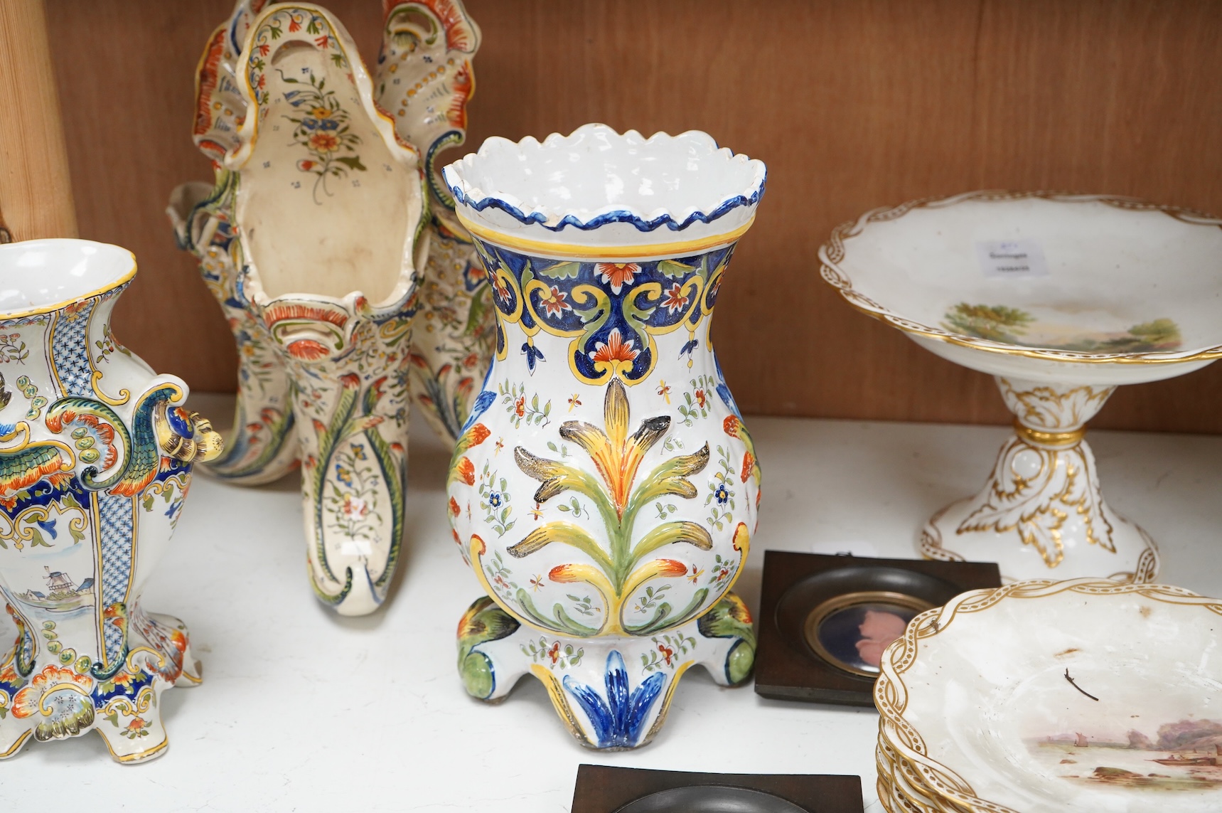 Two late 19th / early 29th century French faience vases and two similar centrepieces, largest 35cm high